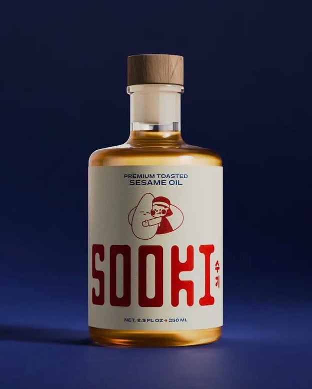Bottle of Sooki sesame oil on a dark blue background