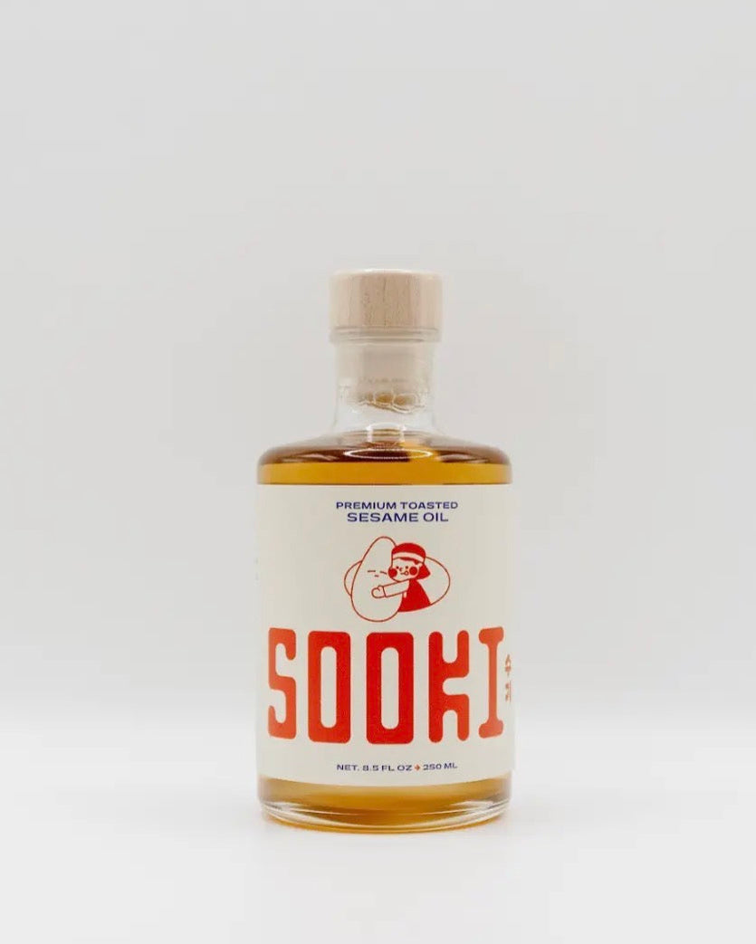 Bottle of Sooki sesame oil on a white background